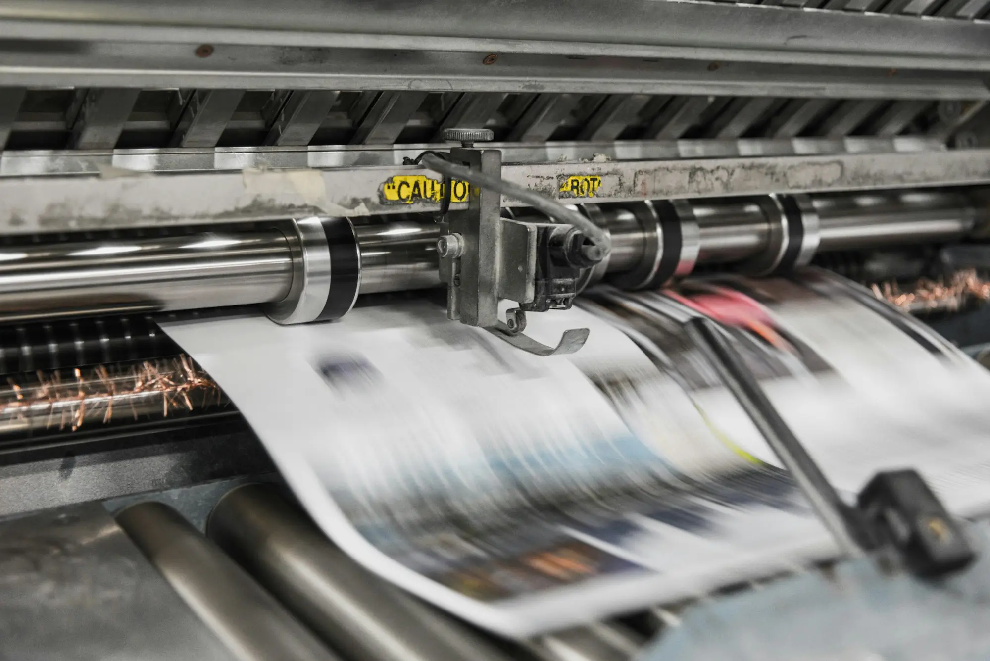 New wide-format printer being set up in a print shop upgrading equipment before the old finance ends