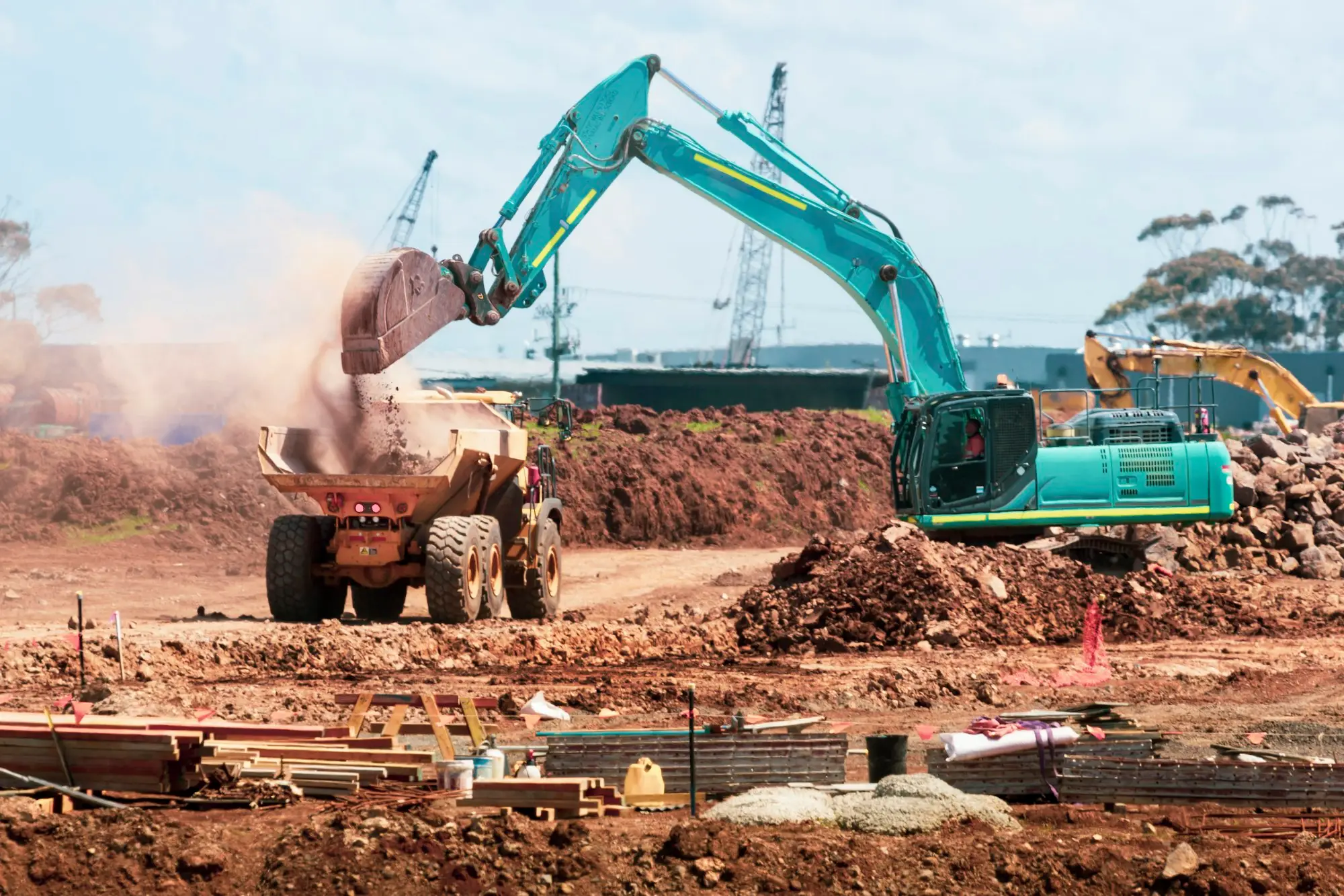 Excavator digging on an earthworks site, typical yellow goods finance equipment